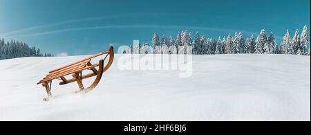 Wooden sledge in a snowy winter landscape Stock Photo