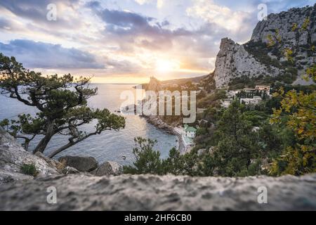 Golden sunset from Panea cliff with mountain cat koshka in background. Simeiz,  Crimea. Black Sea. Stock Photo
