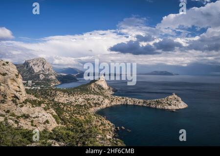 Mount Falcon lit by pink sunset in Novyi Svit during autumn season. Sudak,  the Republic of Crimea. Aerial view. Stock Photo