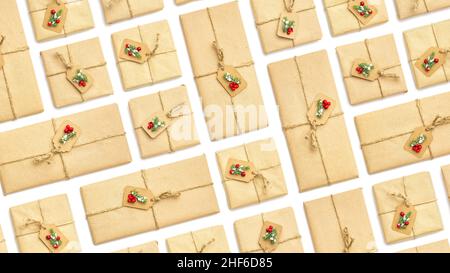 Background from holiday vintage gift packaging with red berries and spruce branches on white isolated background, top view Stock Photo
