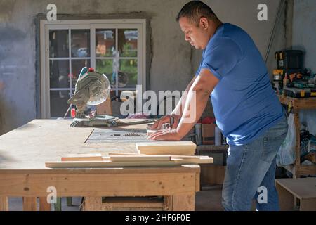 latin man working in a wood workshop Stock Photo