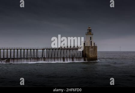 Morning at Blyth beach, with the old wooden Pier stretching out to the North Sea Stock Photo