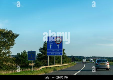 Durham, UK - 23rd August 2019: Blue road sign on a British, UK, motorway advising vehicles and trucks of which lane to be in. Rising fuel price expens Stock Photo