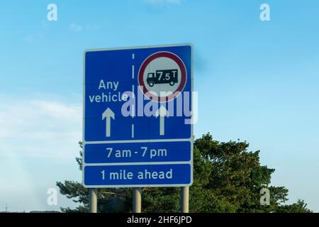 Durham, UK - 23rd August 2019: Blue road sign on a British, UK, motorway advising vehicles and trucks of which lane to be in. Rising fuel price expens Stock Photo