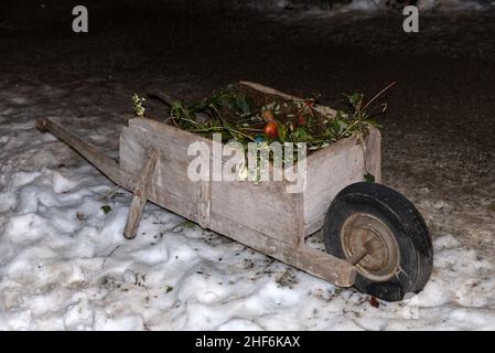 an old wooden wheelbarrow from the 30s in an alpine hut Stock Photo