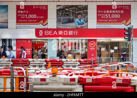 Hong Kong, China. 14th Jan, 2022. Pedestrians walk past the Bank of East Asia (BEA) branch and logo in Hong Kong. (Photo by Budrul Chukrut/SOPA Images/Sipa USA) Credit: Sipa USA/Alamy Live News Stock Photo