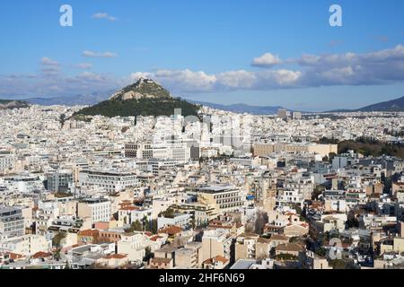 Cityscape of Athens, photo taken from the Acropolis walls. Greek parliament and the Lycabettus hill located in the background. Stock Photo