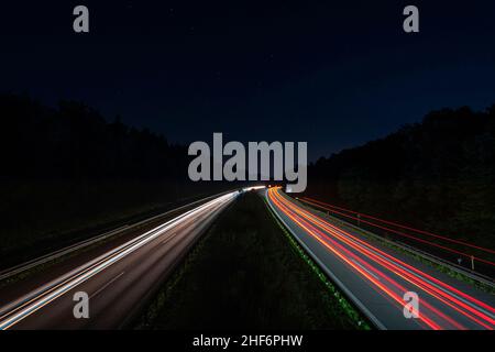 Lighttrails of a traffic motorway from the cars front and headlights,  passing fast the point ov view Stock Photo