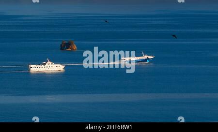 Greece,  Greek Islands,  Ionian Islands,  Corfu,  Corfu Town,  old fortress,  view from there over the sea and offshore rocky islet,  in front of it two boats: on the left a normal small ferry,  on the right a fast hydrofoil Stock Photo