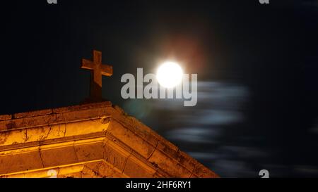 Greece,  Greek Islands,  Ionian Islands,  Corfu,  Corfu Town,  Old Fortress,  night shot,  full moon next to the cross on the roof of the Church of St. George,  clouds under the moon Stock Photo