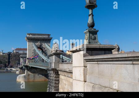 Budapest, Hungary - 12th March 2019: The Széchenyi Chain Bridge is a suspension bridge that spans the River Danube between Buda and Pest, popular with Stock Photo