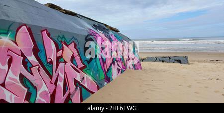 Graffiti on the bunker walls at Plage Le Gurp,  France,  Atlantic coast,  Bordelaise, Stock Photo