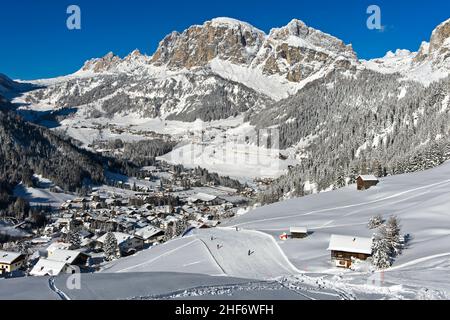 Empty ski slopes at the mountain village of La Villa in front of the snow-covered Dolomite peaks in the Alta Badia ski area,  Dolomites,  South Tyrol,  Italy Stock Photo