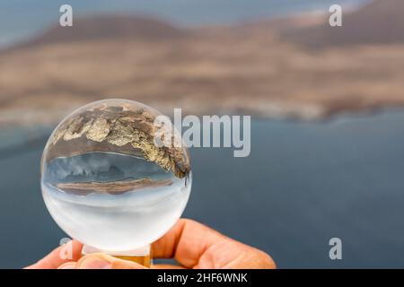 View through a glass ball from the Mirador del Rio to the island of La Graciosa,  Lanzarote,  Canaries,  Canary Islands,  Spain,  Europe Stock Photo