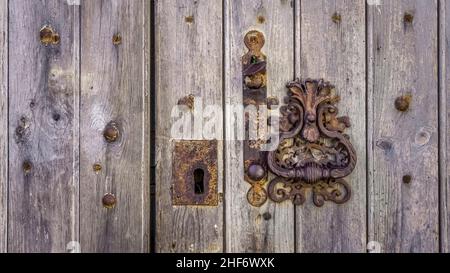 Old door knocker in Assignan. Stock Photo