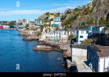 Colorful wooden historic houses built on a hillside, Signal Hill, in St. John's, Newfoundland. The rugged hill overlooks St. john's Harbour in summer. Stock Photo