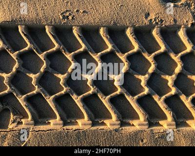 Tire tracks in the sand Stock Photo