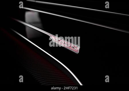 The Chrome Quattro Dashboard Badge On Piano Black Background With Red Mood Lighting On A 2020 Audi RSQ8 Stock Photo