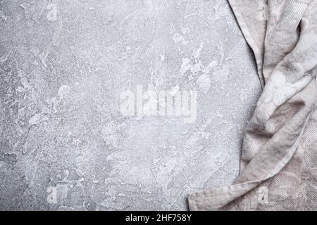 Top view of single folded linen serviette on grey concrete background Stock Photo