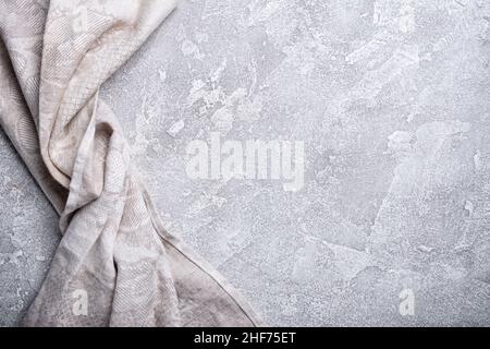 Top view of single folded linen serviette on grey concrete background Stock Photo