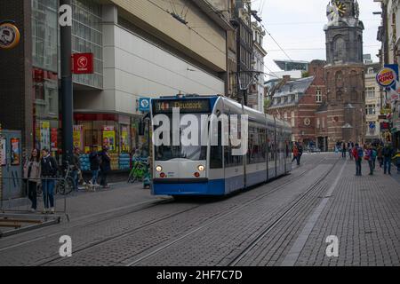 Amsterdam, Holland, The Netherlands - 6th May 2019: S tram down a shopping and eatery street in downtown Amsterdam. Electric city centre tram with tra