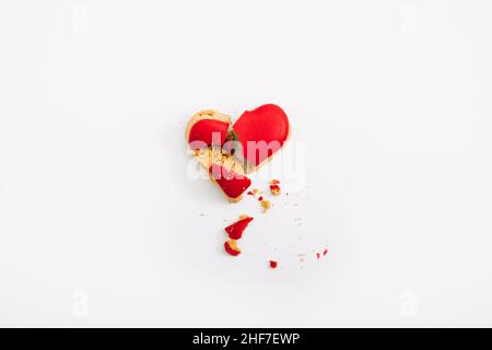 Loneliness, Broken heart, Divorce, couple breakup and relationship family breakdown concept with red Broken heart shape cookies on table. Stock Photo