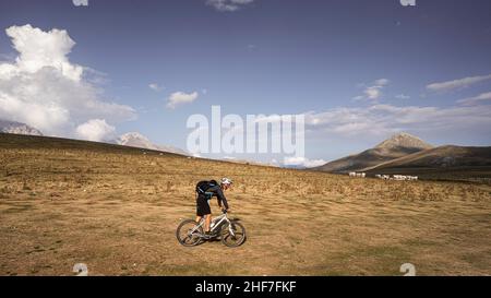 Mountain bikers at an alpine pasture on a mountain road near Santo Stefano di Sessiano,  Abruzzo,  Italy