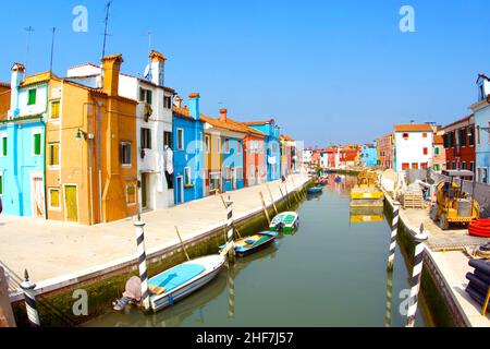 beautiful colored houses and a canal seen from an old brigde of the old fishermans  city Burano in the lagoon of Venice Stock Photo