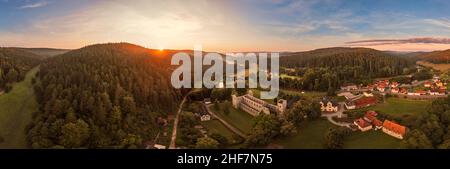 Germany,  Thuringia,  Königsee,  Paulinzella,  monastery ruins,  village,  overview,  mountains,  forest,  sunrise,  partly back light,  panorama Stock Photo