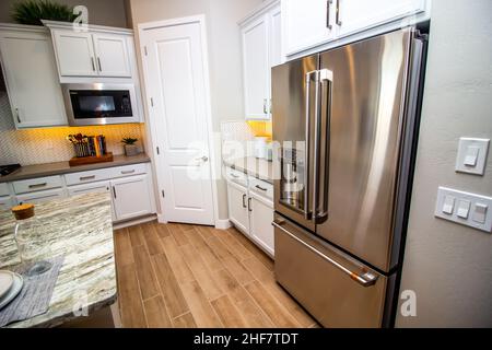 Modern Kitchen With Stainless Steel Appliances And Counter Top Decor Stock Photo