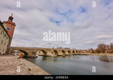 View of the Stone Bridge over the Danube from the historic Wurstkuchl in the old town in the evening light,  Regensburg,  Bavaria,  Germany Stock Photo