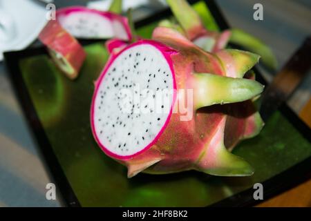 Fresh pink pitahaya. Delicious tropical fruit with a light sweet taste, big shape and a texture between a kiwi and an apple. It contains a lot of wate Stock Photo