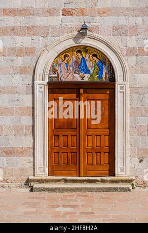 colourful ornate wooden church  door showing lots of intricate detail Stock Photo