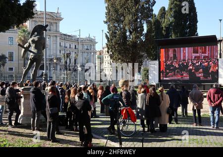 Rome, Italy. 14th Jan, 2022. People attend on a widescreen the funeral Mass of the President of the European Parliament David Sassoli, Rome, Italy, January 14, 2022. Authorities and common people attend the burial service at Santa Maria degli Angeli church.Sassoli, born in Florence, Italy, in 1956, died on January 11 2022 while serving as the President of the European Parliament. He was appointed on July 3 2019. (Photo by Elisa Gestri/Sipa USA) Credit: Sipa USA/Alamy Live News Stock Photo