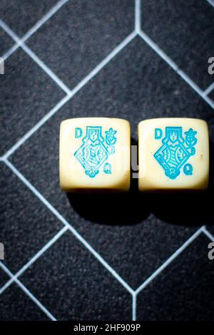 2 blue queens on dice on a black and white background Stock Photo