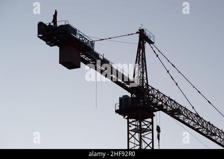 Construction cranes tower over apartment construction sites in downtown Colorado Springs, Colorado Stock Photo