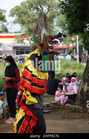 The artist performing Jaranan music dancers and playing a traditional instrument. Jaranan (kuda lumping, kuda kepang) is dance from java Stock Photo