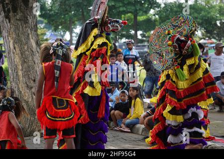 The artist performing Jaranan music dancers and playing a traditional instrument. Jaranan (kuda lumping, kuda kepang) is dance from java Stock Photo