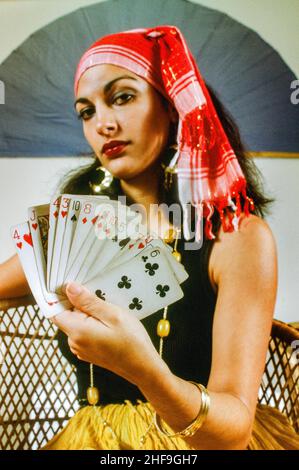 Dressed in a gypsy costume, a young fortune teller poses with her cards in Newport Beach, CA. Stock Photo