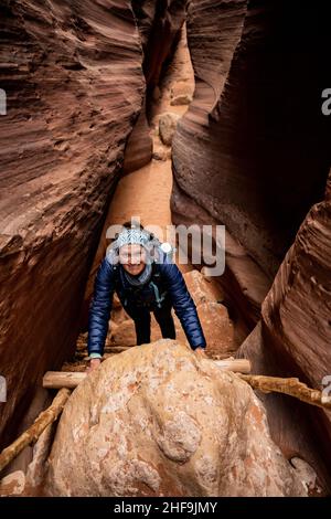 Hiker Climbing Up Boulder Jam In Wire Pass Stock Photo