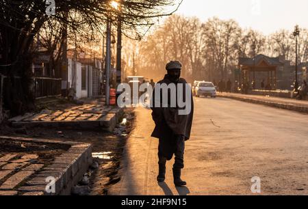 Srinagar, India. 11th Jan, 2022. A man walks along the road during sunset. Credit: SOPA Images Limited/Alamy Live News Stock Photo