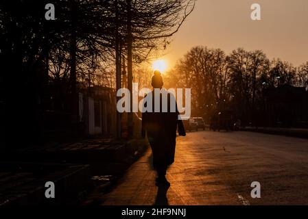 Srinagar, India. 11th Jan, 2022. A silhouette of a man walking along the road during sunset. (Credit Image: © Idrees Abbas/SOPA Images via ZUMA Press Wire) Stock Photo