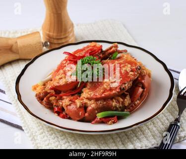 Chilli Mud Crab, Crab with Singaporean Sauce, Special Singapore Cuisine. Served on White Plate Stock Photo