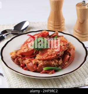 Chilli Mud Crab, Crab with Singaporean Sauce, Special Singapore Cuisine. Served on White Plate Stock Photo