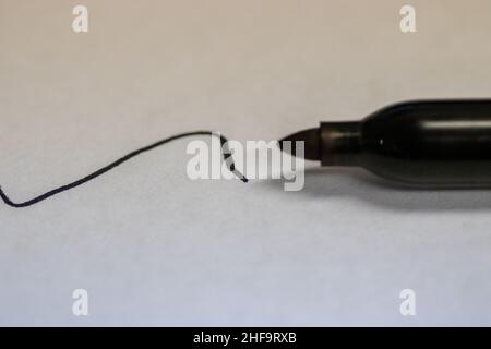 Permanent sharpie Marker close up written black line on white paper . High quality photo Stock Photo