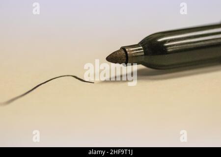 Permanent sharpie Marker close up written black line on white paper . High quality photo Stock Photo