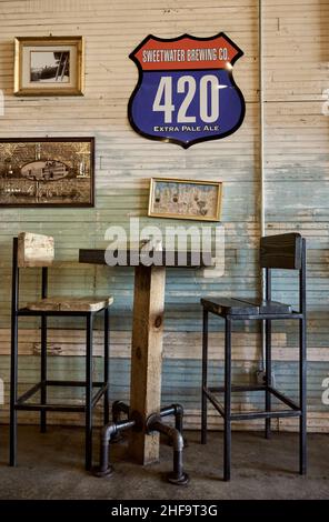 Restaurant high top table for two and vintage decor in the quaint small town Pizza and Pints restaurant in Sylacauga Alabama, USA. Stock Photo