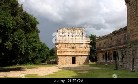 Small temple bearing many masks in the Nunnery complex, aka 'La Iglesia' ('the Church'), Chichen-Itza, Yucatan, Mexico Stock Photo