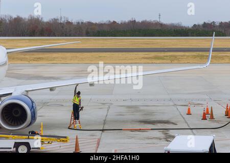 Refueling of airplane at airport Preparations before flight Stock Photo