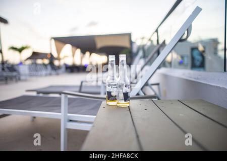 Two empty beer bottles on wooden table with blurry background Stock Photo